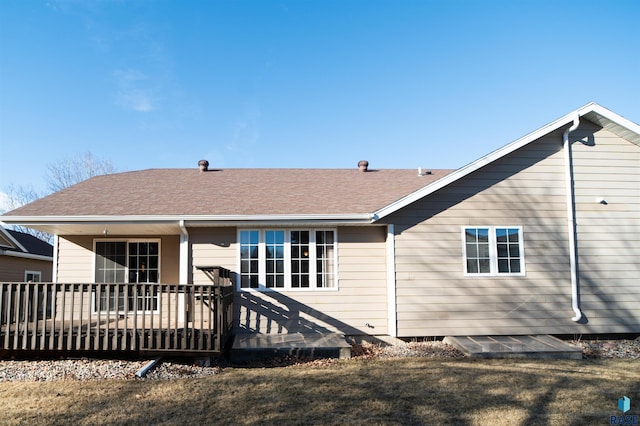 back of property featuring a yard and a deck