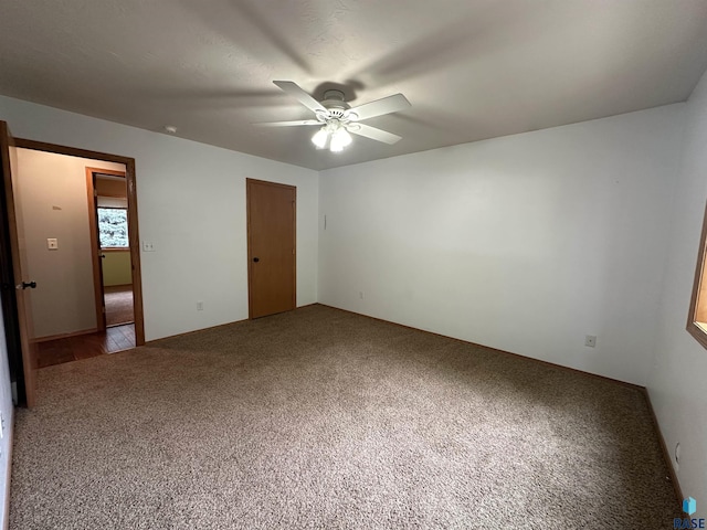 unfurnished bedroom with ceiling fan and carpet flooring