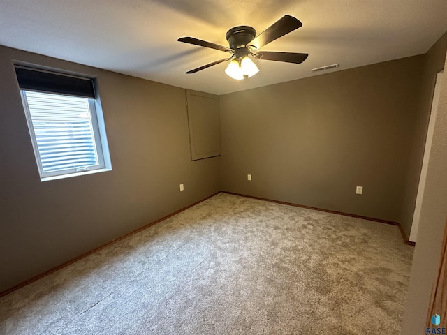 spare room featuring ceiling fan and carpet floors