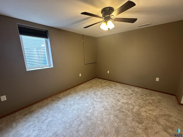 spare room with carpet and ceiling fan