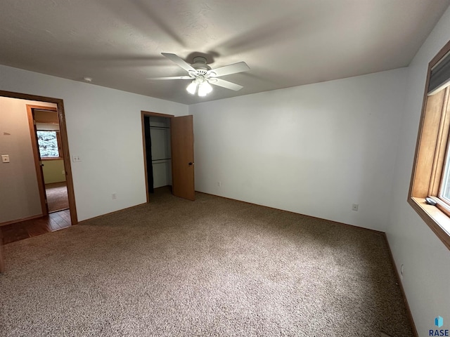 unfurnished bedroom with a closet, ceiling fan, and carpet