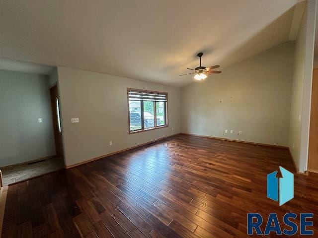 spare room featuring vaulted ceiling, dark hardwood / wood-style floors, and ceiling fan