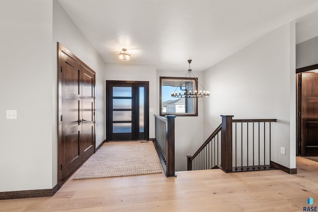 entryway featuring a notable chandelier and light hardwood / wood-style floors