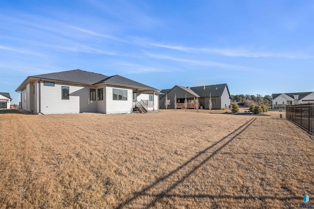 rear view of property featuring a yard