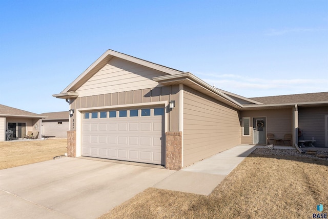 ranch-style home with a garage and a front yard