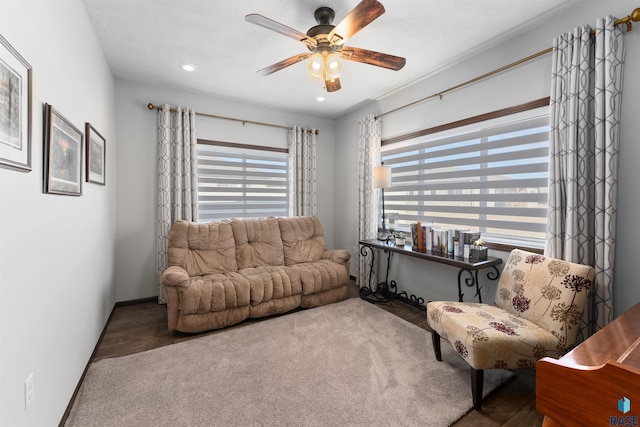 living room featuring ceiling fan and a healthy amount of sunlight