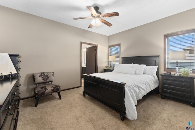 carpeted bedroom with ceiling fan and multiple windows