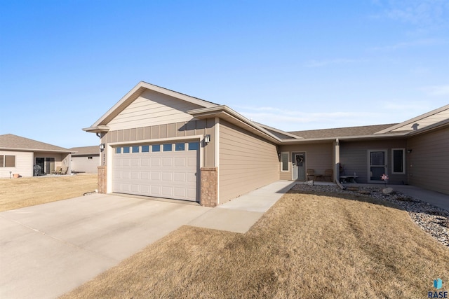 single story home featuring a garage and a front lawn