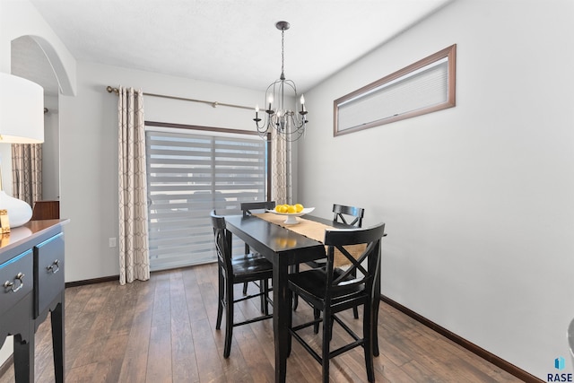 dining space featuring an inviting chandelier and dark hardwood / wood-style flooring