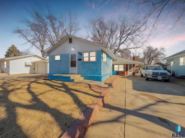 view of front facade featuring a garage and an outdoor structure