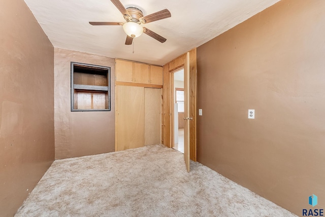 unfurnished bedroom with a closet, ceiling fan, and carpet