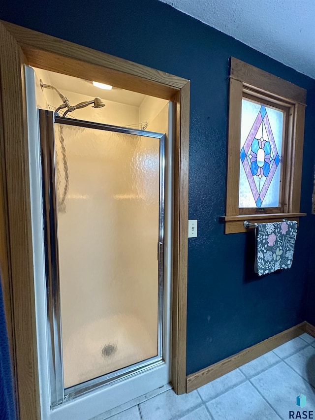 bathroom featuring tile patterned floors and an enclosed shower