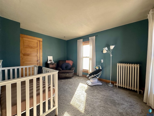 bedroom featuring carpet floors, a nursery area, and radiator