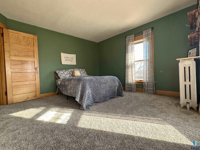 carpeted bedroom with radiator heating unit