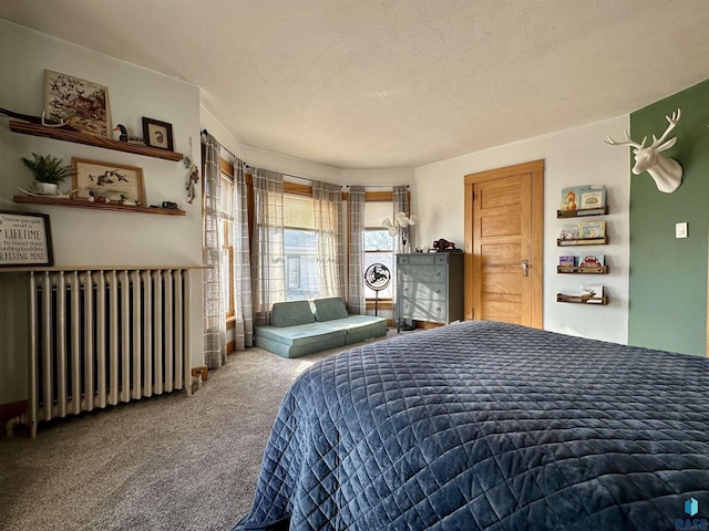 bedroom featuring carpet floors, radiator heating unit, and a textured ceiling