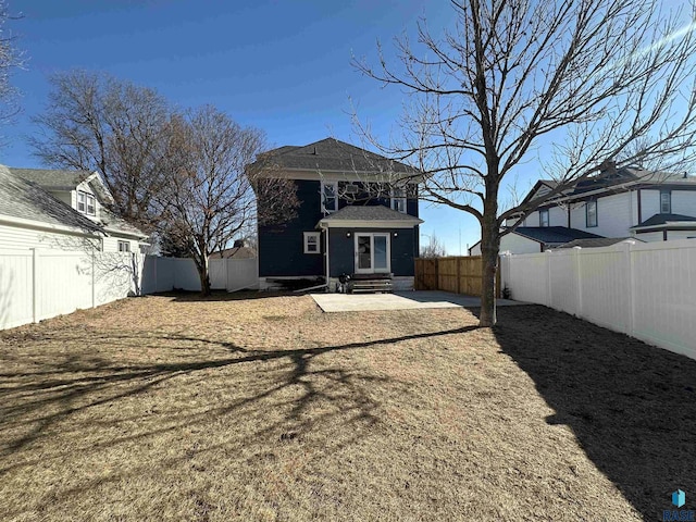 back of house featuring a patio and a lawn