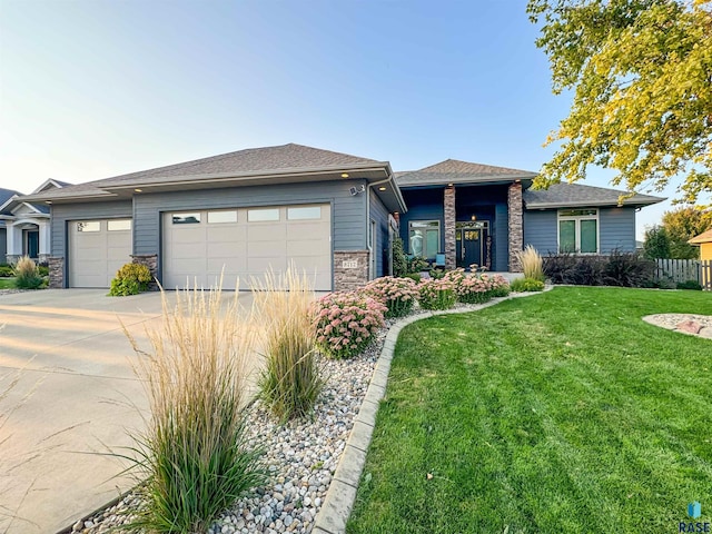 prairie-style home featuring a garage and a front yard