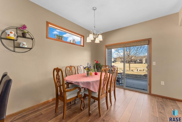 dining area with an inviting chandelier and hardwood / wood-style floors