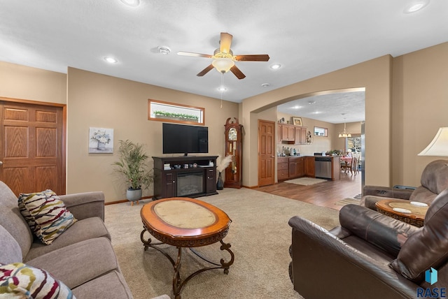 carpeted living room featuring ceiling fan