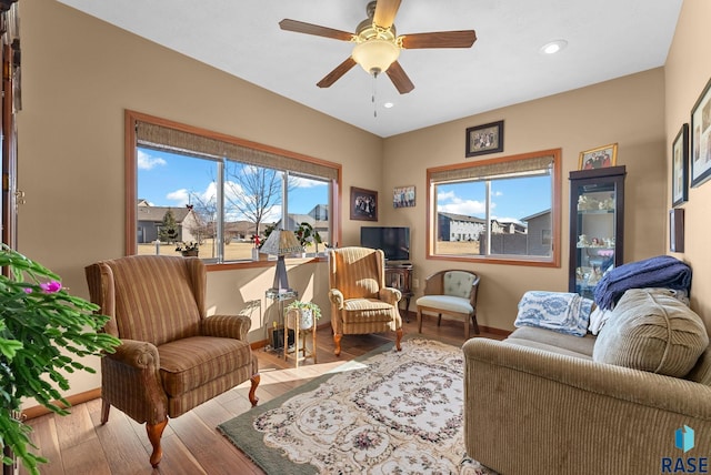 sitting room with light hardwood / wood-style flooring and ceiling fan