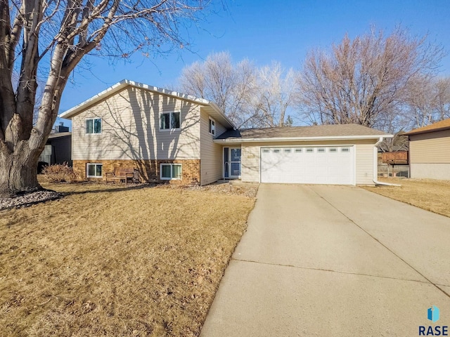 split level home with a garage and a front yard