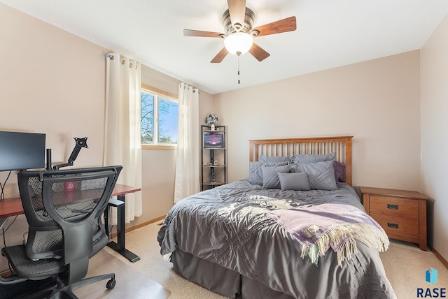 bedroom with ceiling fan and light carpet