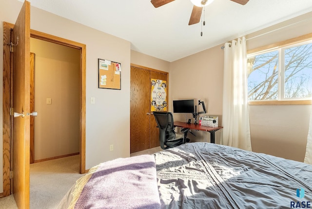 carpeted bedroom with ceiling fan and a closet