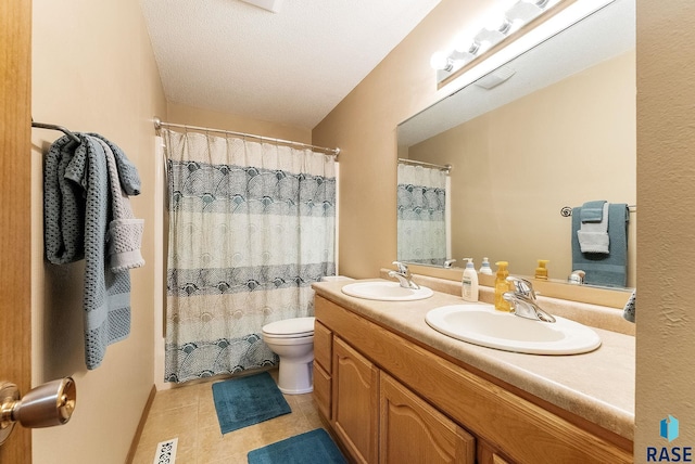 bathroom featuring vanity, walk in shower, tile patterned floors, and toilet