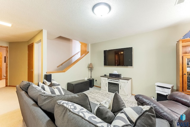 carpeted living room with a textured ceiling