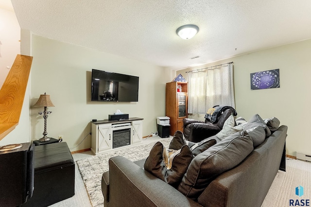 carpeted living room with a textured ceiling