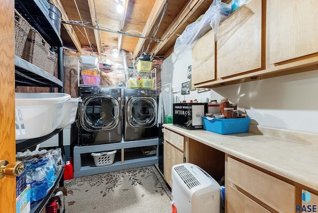 laundry room with cabinets and separate washer and dryer