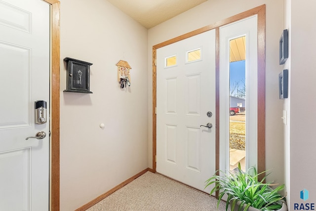 view of carpeted foyer