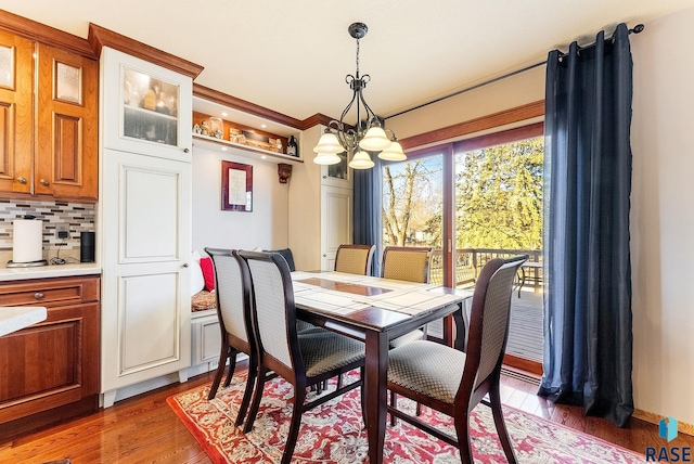 dining room featuring dark hardwood / wood-style floors and an inviting chandelier