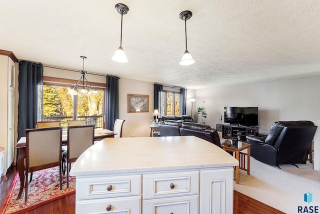 kitchen featuring decorative light fixtures, dark hardwood / wood-style floors, and white cabinets