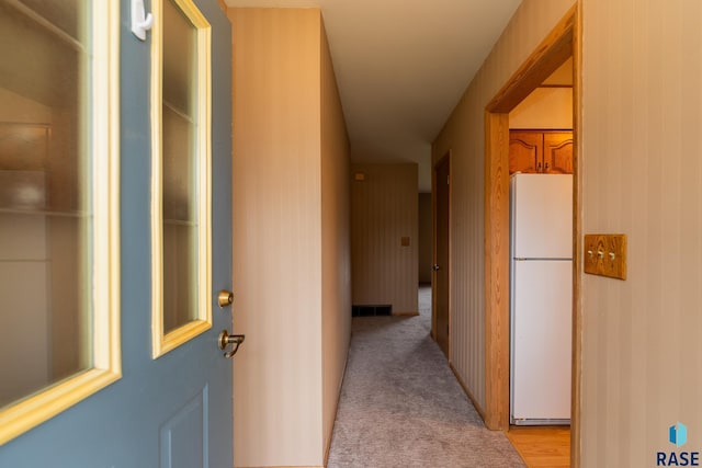 hallway featuring light colored carpet