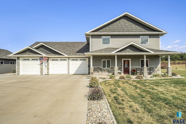 craftsman-style home featuring a garage, a front yard, and a porch