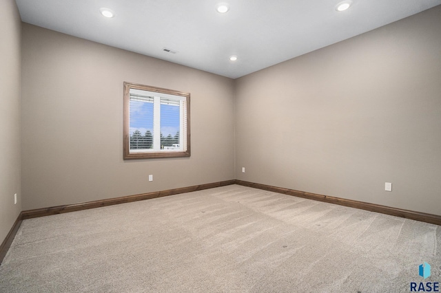 empty room featuring light colored carpet