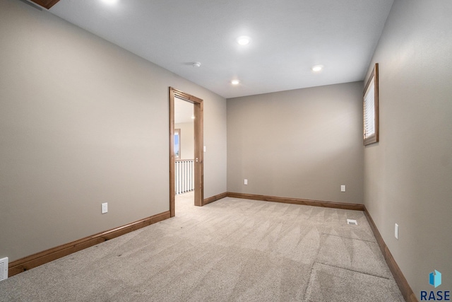 unfurnished room with light colored carpet