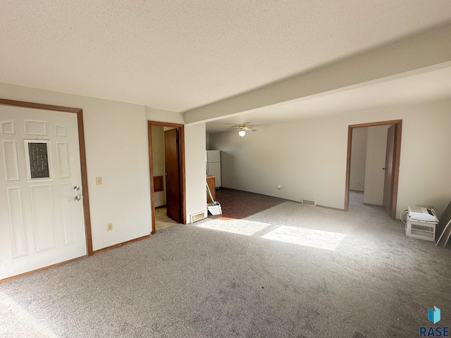 interior space with ceiling fan, carpet, and a textured ceiling