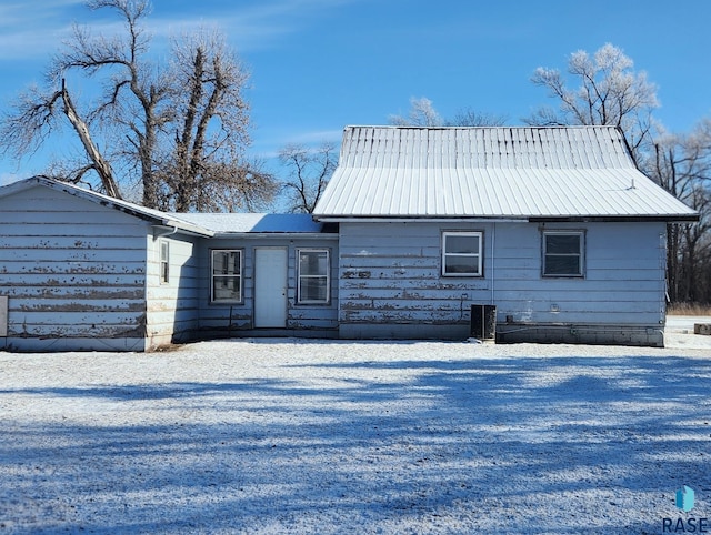 snow covered property featuring central air condition unit