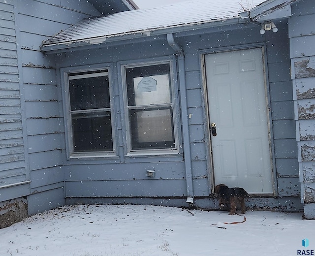 view of snow covered property entrance