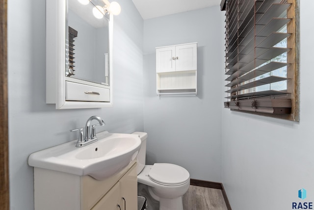 bathroom featuring vanity, hardwood / wood-style floors, and toilet