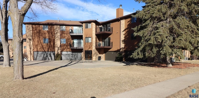 view of property with driveway and an attached garage