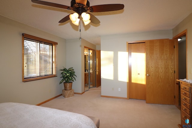 carpeted bedroom featuring ensuite bath and ceiling fan