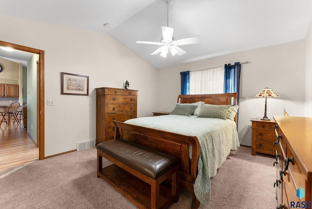 bedroom featuring lofted ceiling, light carpet, and ceiling fan