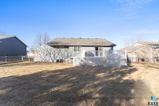 rear view of property with a yard and a deck