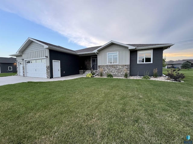 single story home featuring a yard and a garage