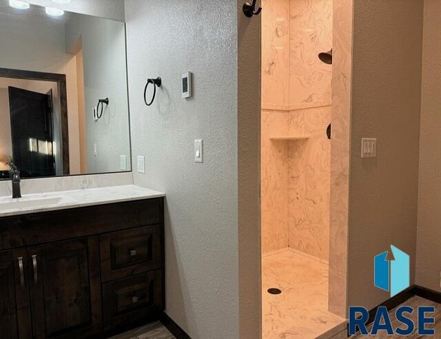 bathroom with vanity and a shower