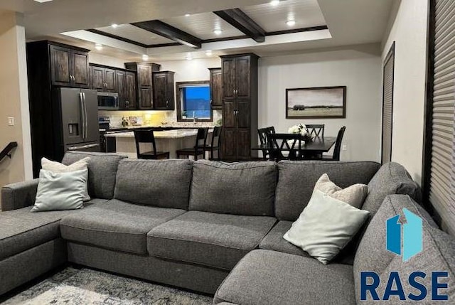 living room featuring beamed ceiling