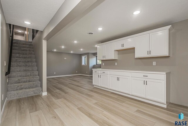 kitchen featuring white cabinetry and light hardwood / wood-style flooring